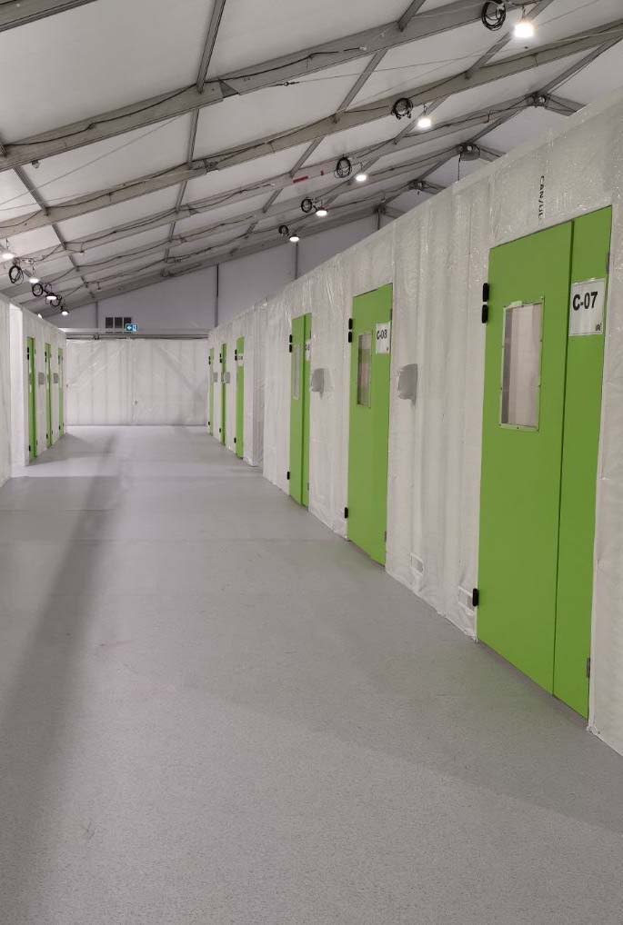 Disaster relief tent being set up as emergency shelter for displaced residents during response operations