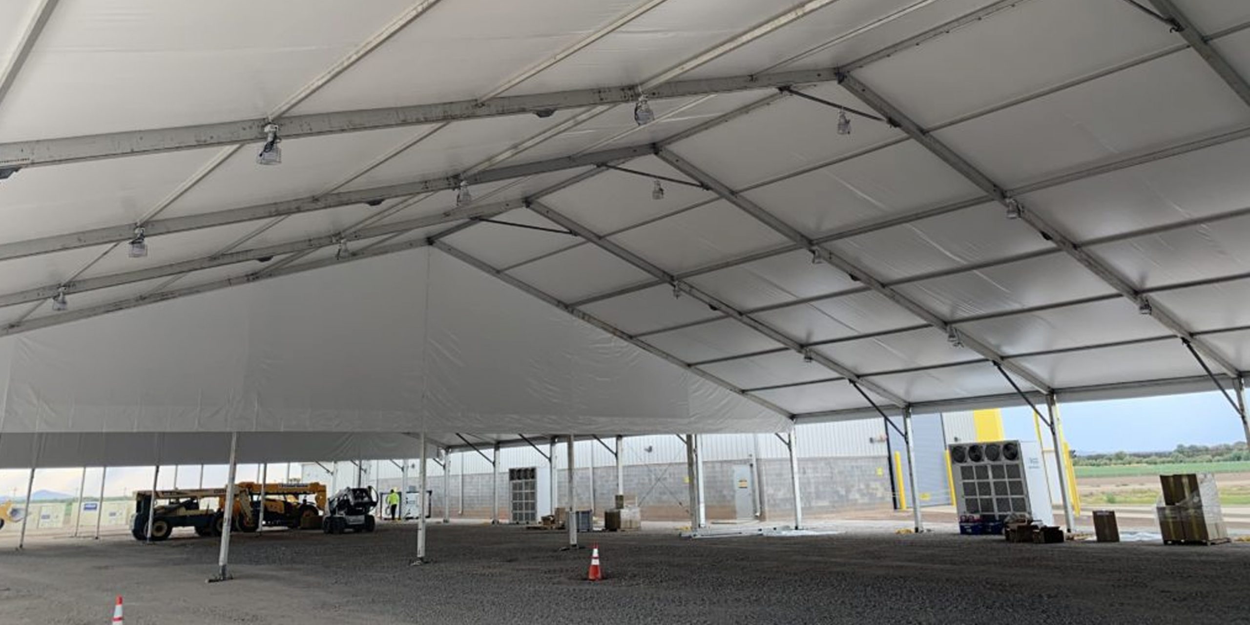 Massive clearspan emergency response tent configured as a command post with industrial infrastructure and open workspace