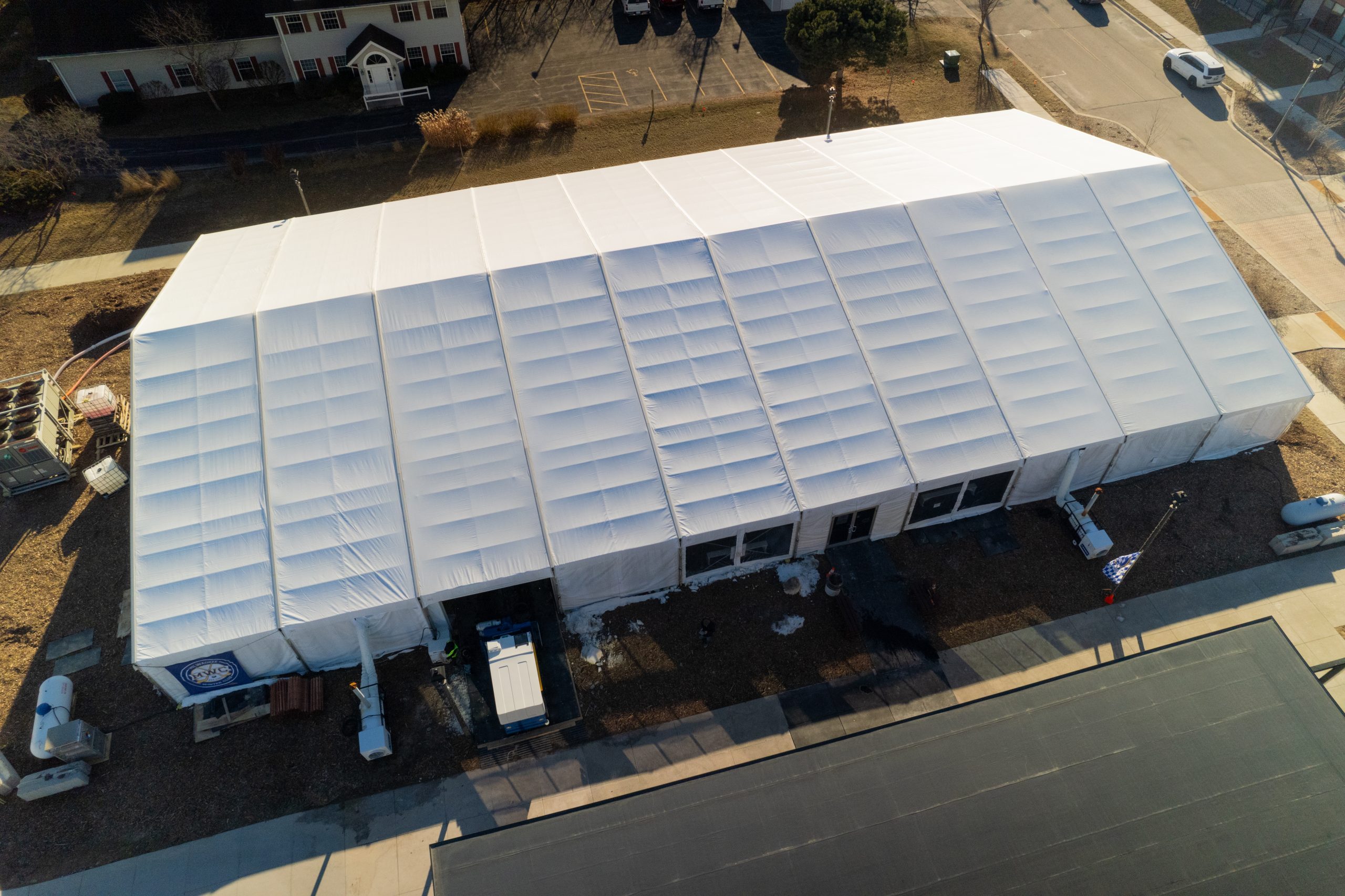 Aerial view of construction tent structure installed over an underground excavation and pipe work site